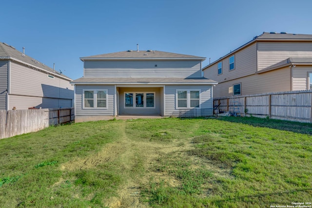 back of property featuring a yard