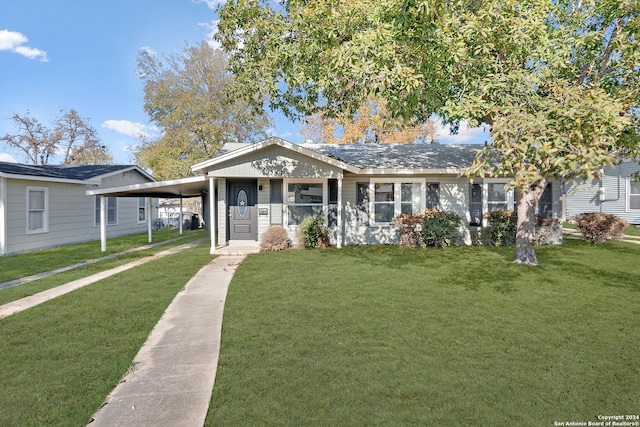 view of front facade with a front yard and a carport