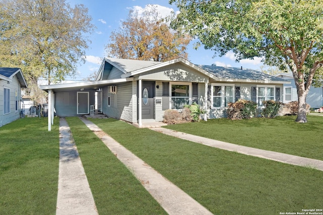 bungalow-style home with a front yard and a carport