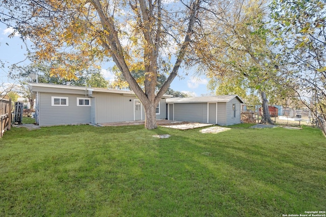 rear view of house with a yard