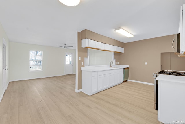 kitchen with dishwasher, sink, white gas range, light wood-type flooring, and white cabinetry