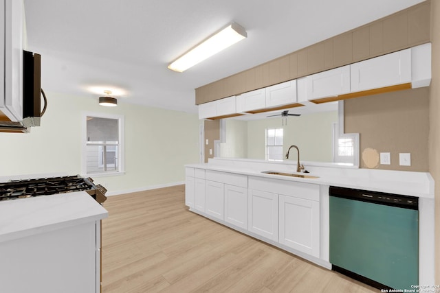 kitchen featuring white cabinetry, sink, ceiling fan, stainless steel dishwasher, and light wood-type flooring