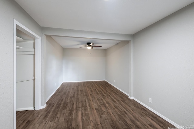 unfurnished room featuring dark hardwood / wood-style floors and ceiling fan