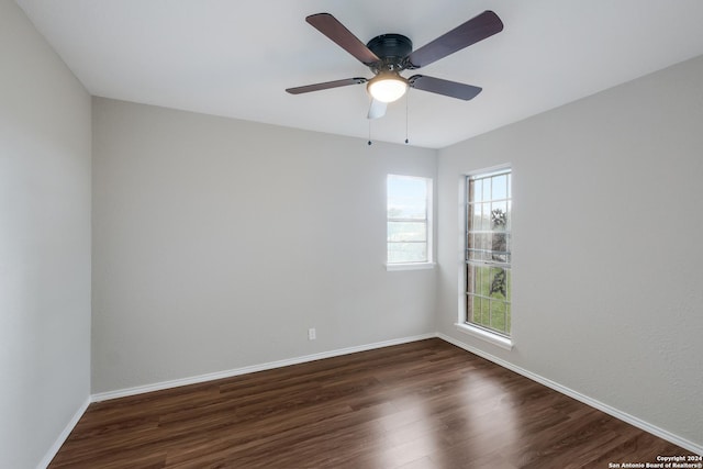 spare room with ceiling fan and dark hardwood / wood-style flooring