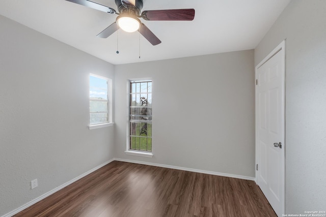 unfurnished room featuring dark hardwood / wood-style floors and ceiling fan