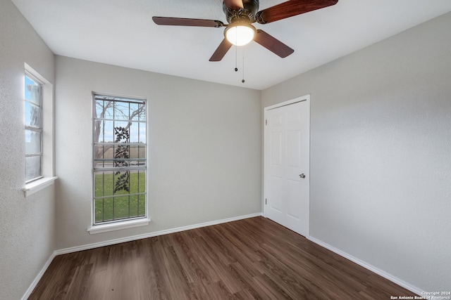 unfurnished room featuring dark hardwood / wood-style floors and ceiling fan