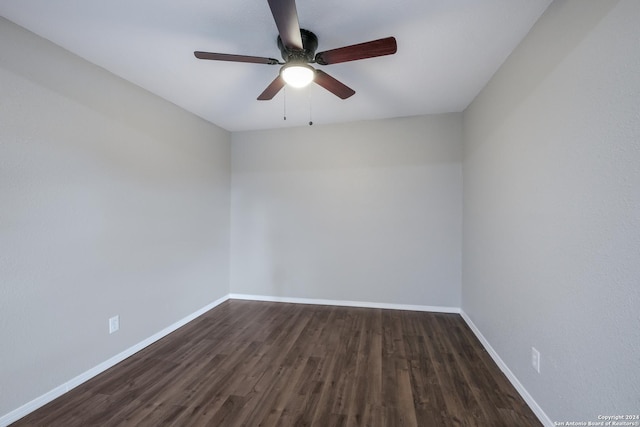 spare room with ceiling fan and dark hardwood / wood-style flooring