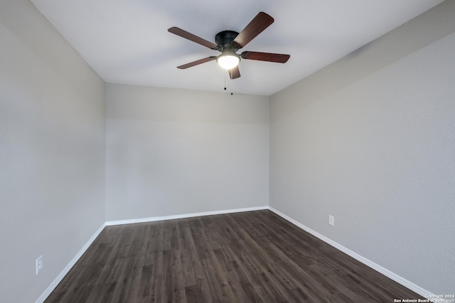 spare room with dark hardwood / wood-style flooring and ceiling fan