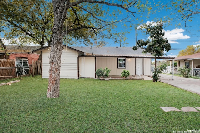 exterior space featuring a front yard and a carport