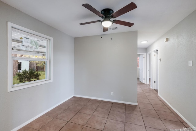 tiled empty room with ceiling fan