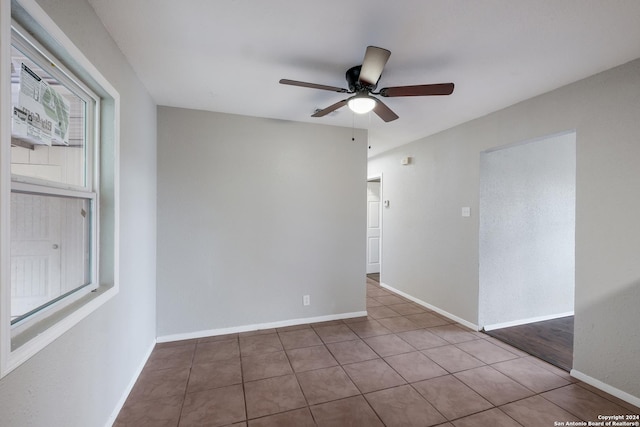 empty room featuring tile patterned floors and ceiling fan