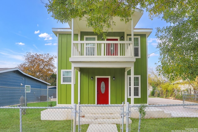 view of front of property with a balcony and central AC