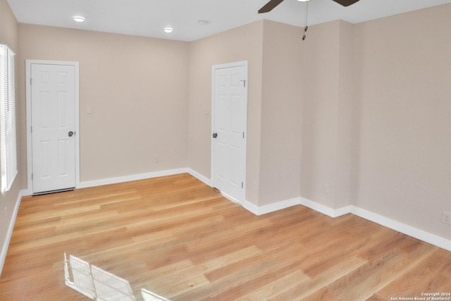 unfurnished room with ceiling fan and wood-type flooring