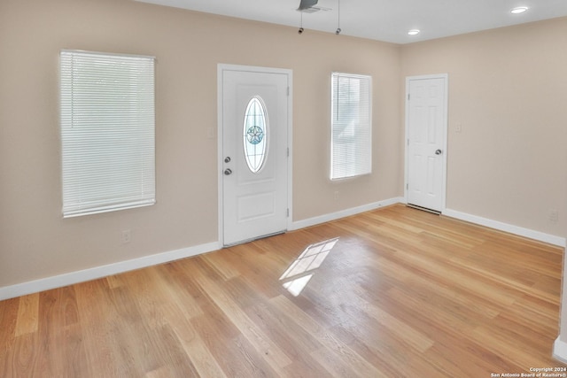 entryway with ceiling fan and light hardwood / wood-style flooring