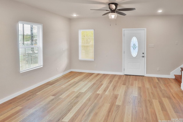 foyer with ceiling fan and light wood-type flooring