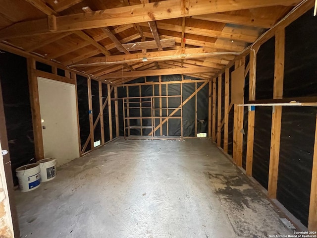 miscellaneous room with concrete floors and vaulted ceiling