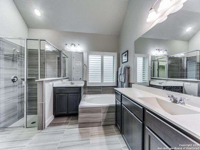 bathroom with shower with separate bathtub, vanity, and lofted ceiling