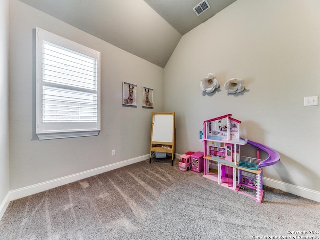 rec room featuring carpet flooring and vaulted ceiling