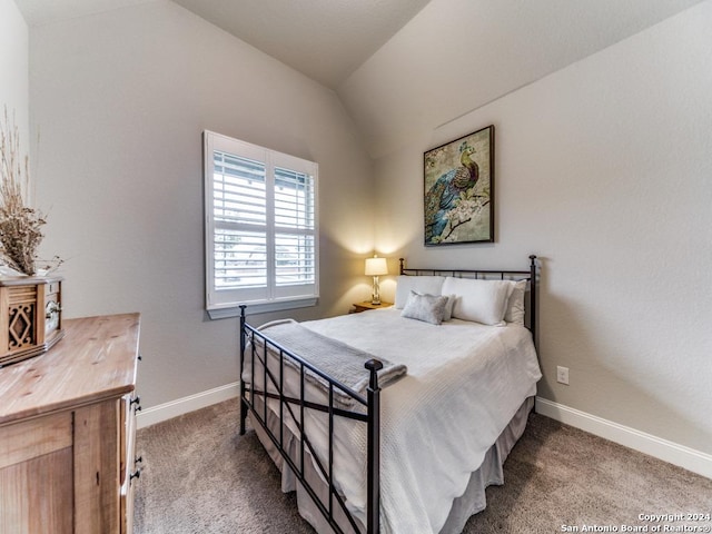 carpeted bedroom with lofted ceiling