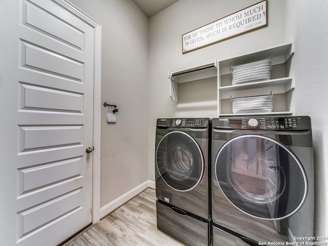 washroom featuring separate washer and dryer and light hardwood / wood-style floors