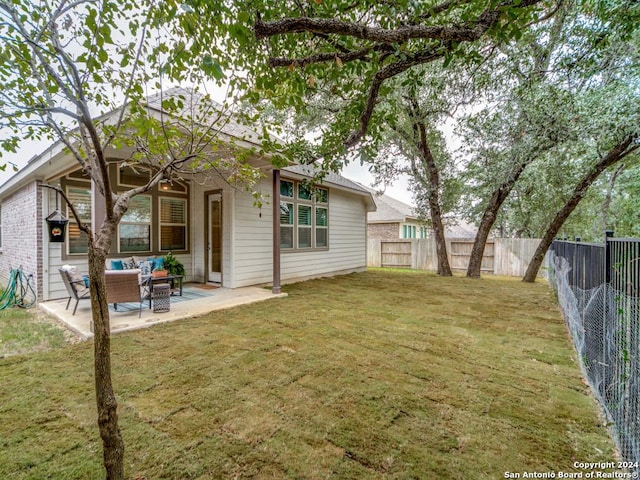 back of property featuring an outdoor hangout area, a patio area, and a lawn