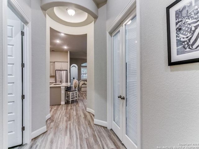 hallway with light hardwood / wood-style flooring