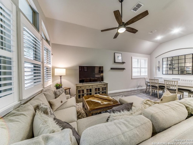 living room with ceiling fan and vaulted ceiling