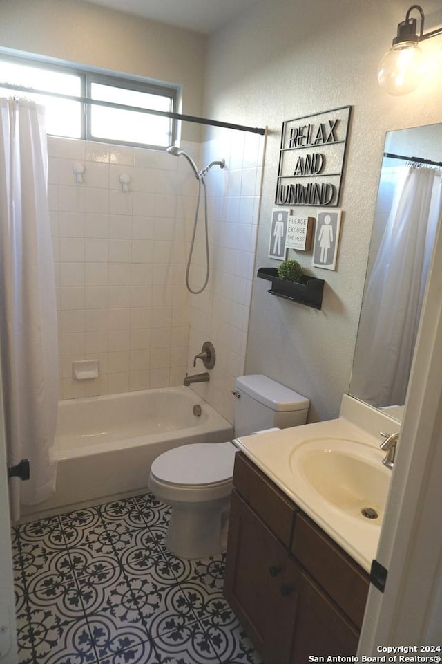 full bathroom featuring tile patterned flooring, shower / tub combo, vanity, and toilet