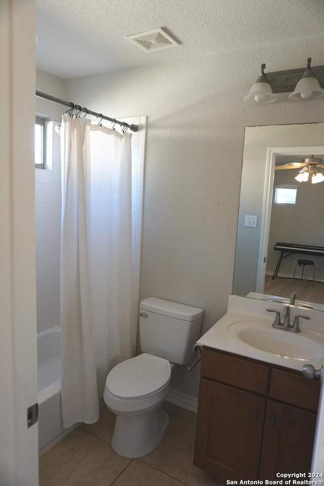 full bathroom featuring vanity, tile patterned flooring, ceiling fan, toilet, and shower / tub combo