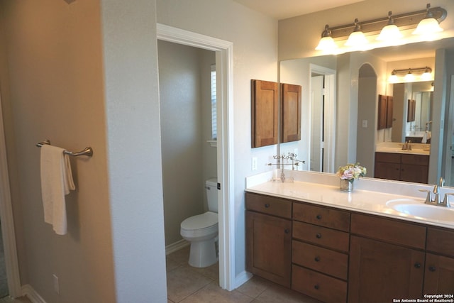 bathroom with tile patterned flooring, vanity, and toilet