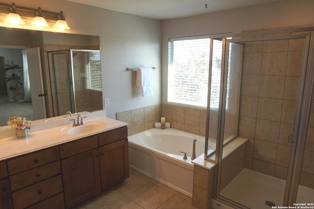 bathroom with tile patterned floors, vanity, and independent shower and bath