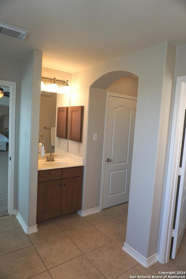 bathroom with ceiling fan, tile patterned flooring, and vanity