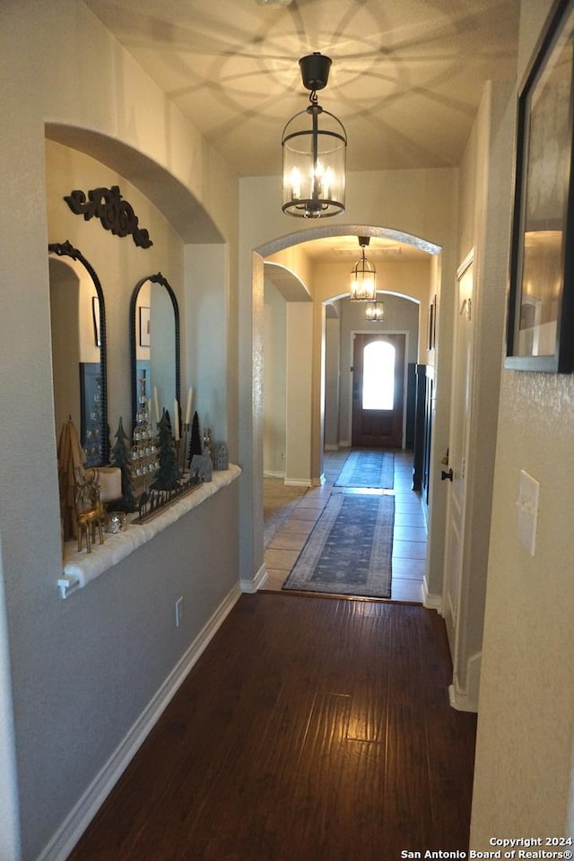 interior space featuring hardwood / wood-style floors and a notable chandelier