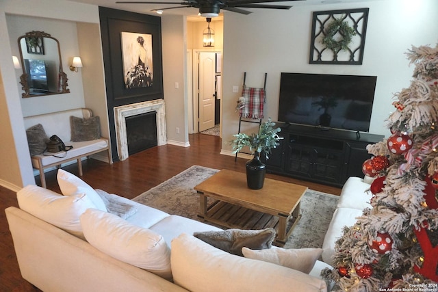 living room with ceiling fan and dark wood-type flooring