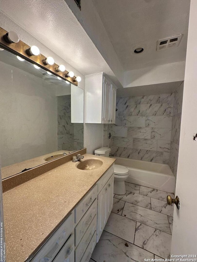 full bathroom with vanity, toilet, and tiled shower / bath combo