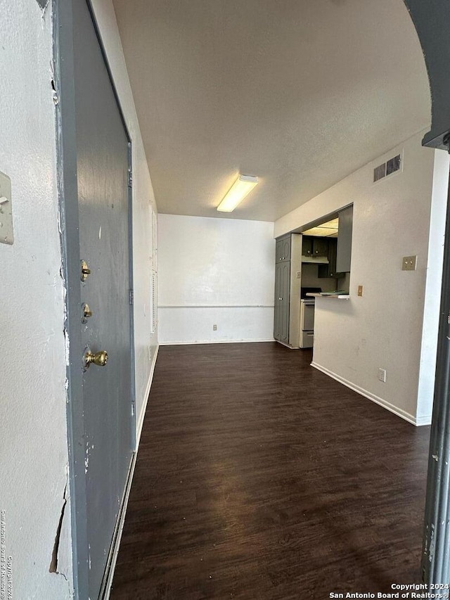 unfurnished living room with dark wood-type flooring