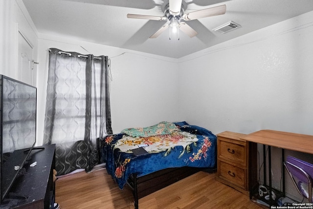 bedroom with ceiling fan and hardwood / wood-style flooring