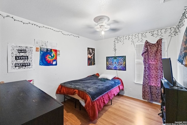 bedroom with ceiling fan and hardwood / wood-style flooring