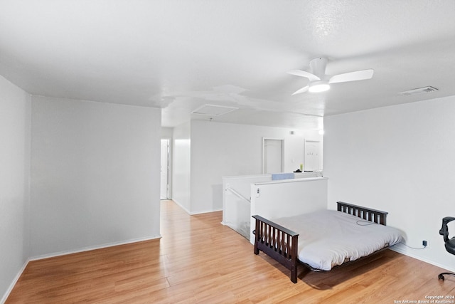 bedroom with ceiling fan and light hardwood / wood-style flooring