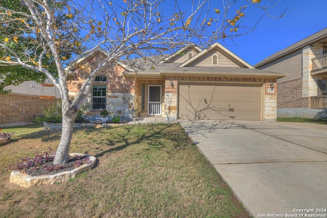 ranch-style house featuring a garage and a front lawn