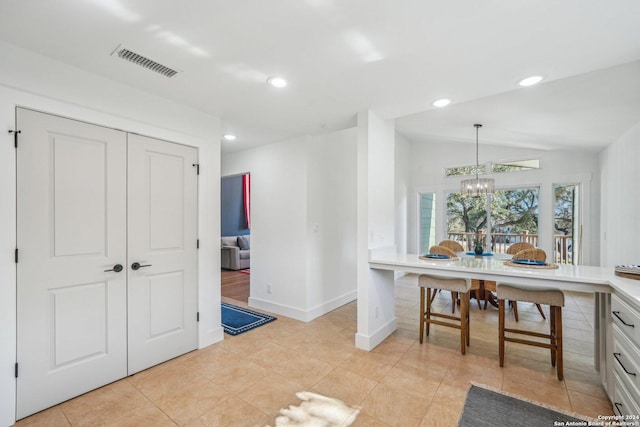 interior space featuring a chandelier and lofted ceiling