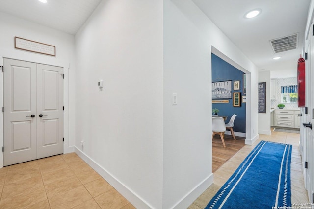 hallway featuring light tile patterned floors