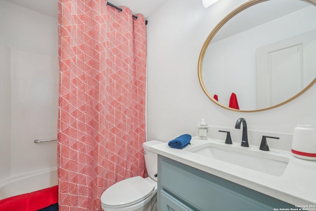 bathroom featuring toilet, vanity, and a shower with shower curtain