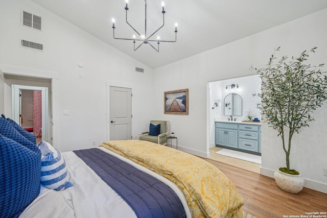 bedroom with connected bathroom, light hardwood / wood-style flooring, high vaulted ceiling, and sink