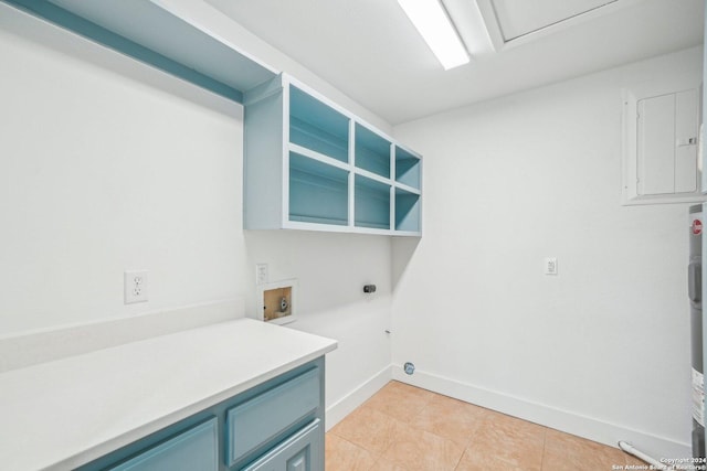 washroom with hookup for an electric dryer, washer hookup, cabinets, electric panel, and light tile patterned flooring