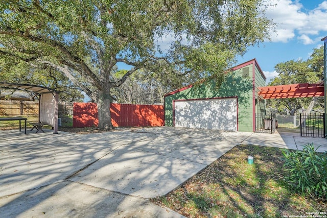 view of patio featuring a garage and a pergola