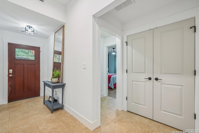 tiled entrance foyer featuring ceiling fan