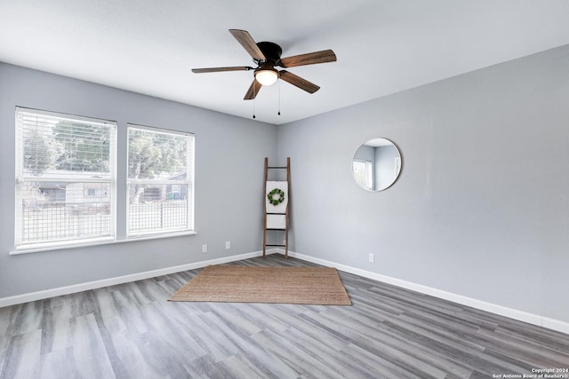 empty room with wood-type flooring and ceiling fan