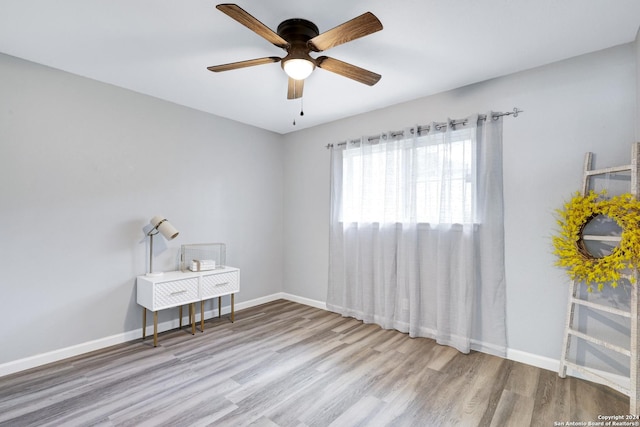 spare room featuring ceiling fan and light wood-type flooring