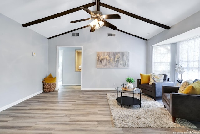 living room with beam ceiling, light hardwood / wood-style floors, high vaulted ceiling, and ceiling fan